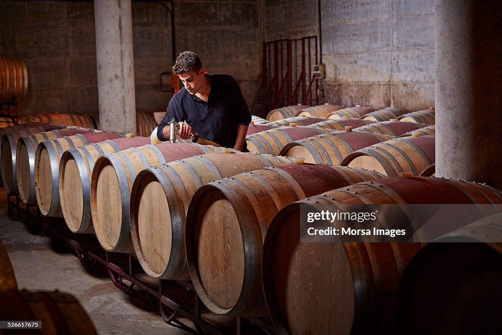 Worker filling up the barrels