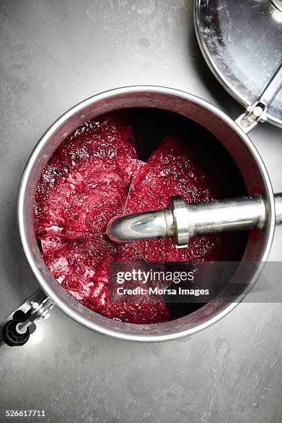 red wine must being pumped over - winemaking stock-fotos und bilder