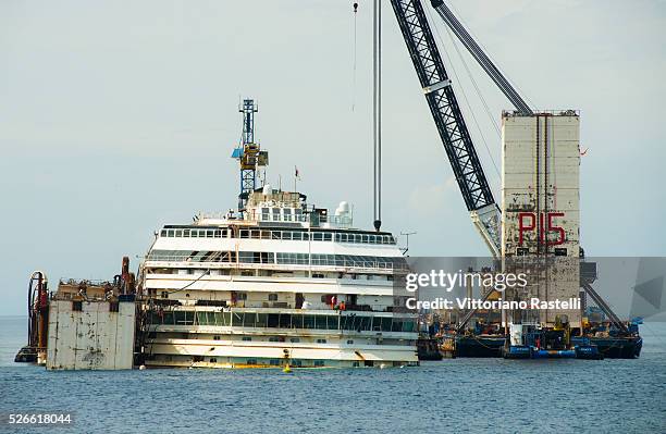 Floating crane carries the last water tank to be put on one side of the Italian cruiser Costa Concordia June 28, 2014. The Concordia ran aground the...