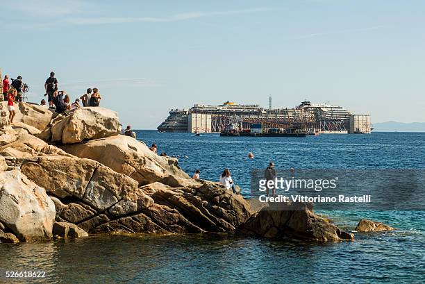 Giglio isle, Italy. Two powerful tugboats carry away the Costa Concordia cruise liner from the Giglio isle. Wednesday July 23 2014, more that two...