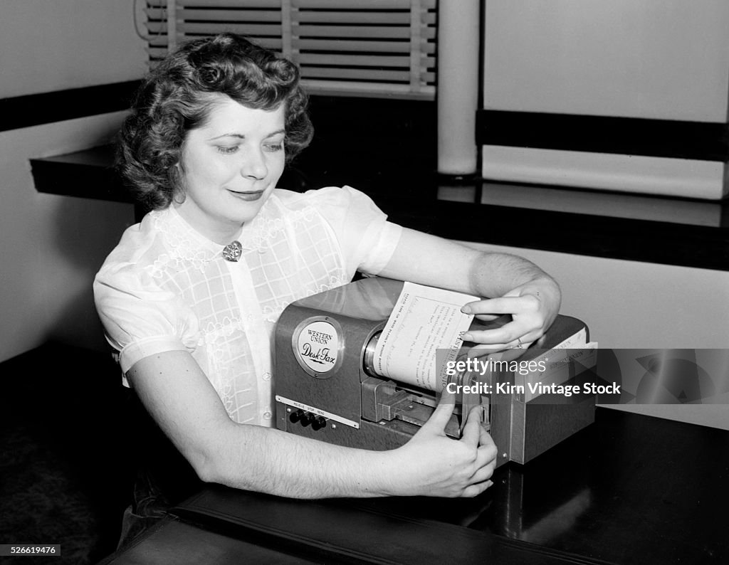 Young woman demonstrates Western Union device, ca. 1950.
