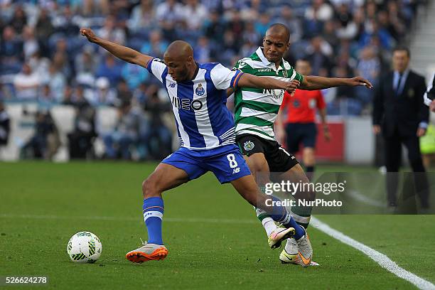 Porto's Algerian forward Yacine Brahimi in action with Sporting's Portuguese midfielder Jo��o M��rio during the Premier League 2015/16 match between...