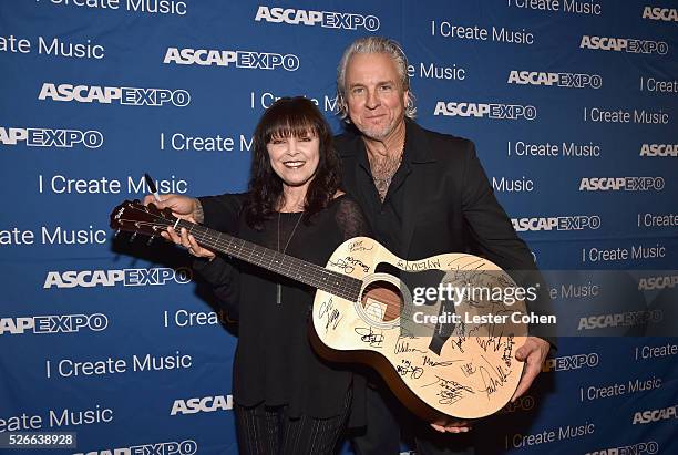Singer Pat Benatar and musician Neil Giraldo pose with a #StandWithSongwriters guitar, which will be presented in May to members of Congress to urge...