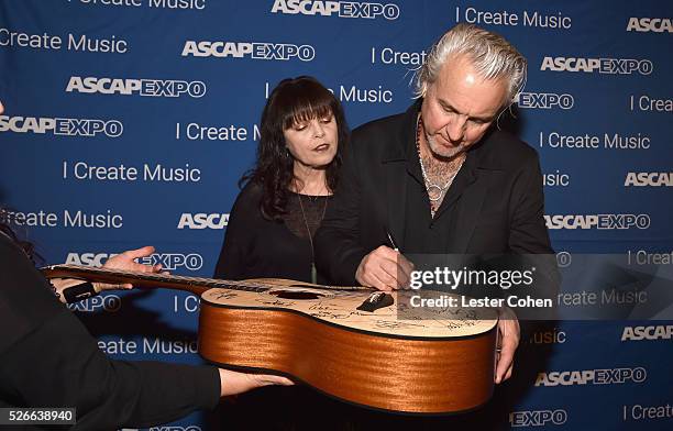 Singer Pat Benatar and musician Neil Giraldo sign a #StandWithSongwriters guitar, which will be presented in May to members of Congress to urge them...