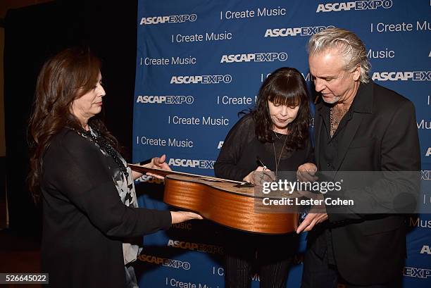 Siinger Pat Benatar and musician Neil Giraldo pose with a #StandWithSongwriters guitar, which will be presented in May to members of Congress to urge...