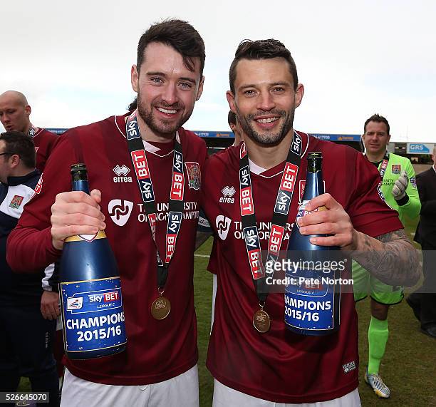Brendan Molony and Marc Richards of Northampton Town celebrate with champagne after the Sky Bet League Two match between Northampton Town and Luton...