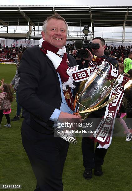 Northampton Town manager Chris Wilder celebrates with the the Sky Bet League Two champions trophy after Sky Bet League Two match between Northampton...