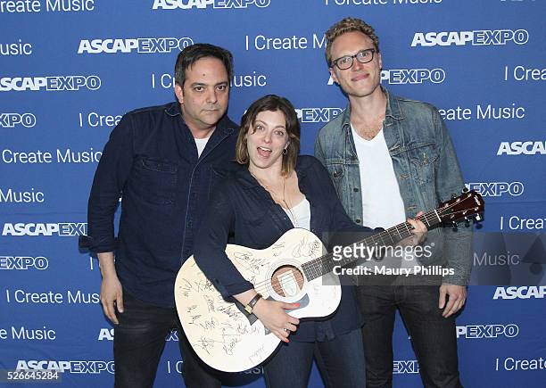 Composer Adam Schlesinger, actress/singer Rachel Bloom and Jack Dolgen pose with a #StandWithSongwriters guitar, which will be presented in May to...