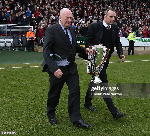 Former manager Graham Carr, who was the last Northampton Town manager to win a championship and current chairman Kelvin Thomas walk out with the Sky...