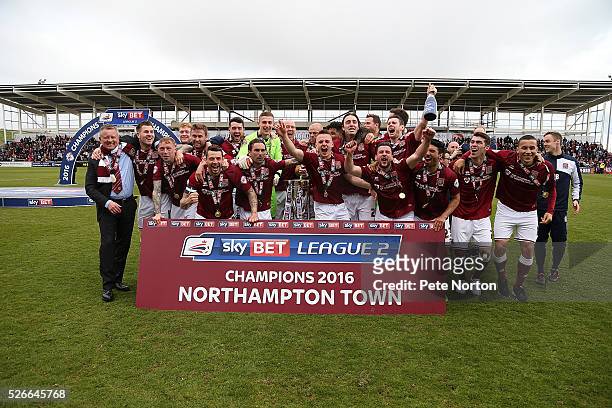 Northampton Town players celebrate after recieving the Sky Bet League Two champions trophy after Sky Bet League Two match between Northampton Town...