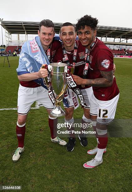 Zander Diamond Rod McDonald and Josh Lelan of Northampton Town celebrate with the Sky Bet League Two champions trophy after the Sky Bet League Two...