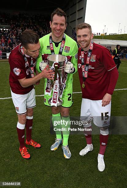Alfie Potter Ryan Clarke and Lawson D'Ath of Northampton Town celebrate with the Sky Bet League Two champions trophy after the Sky Bet League Two...