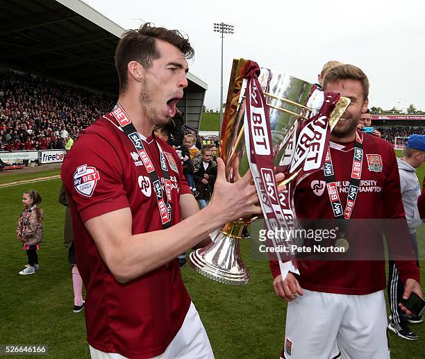 John Marquis of Northampton Town celebrates and the Sky Bet League Two champions trophy after the Sky Bet League Two match between Northampton Town...