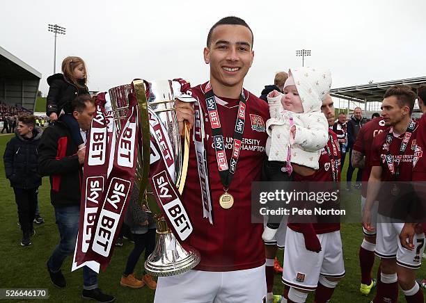 Rod McDonald of Northampton Town celebrates with his daughter and the Sky Bet League Two champions trophy after the Sky Bet League Two match between...