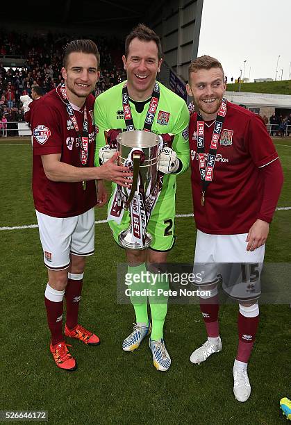 Alfie Potter Ryan Clarke and Lawson D'Ath of Northampton Town celebrate with the Sky Bet League Two champions trophy after the Sky Bet League Two...