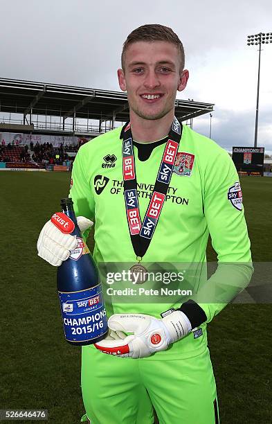 Adam Smith of Northampton Town celebrates with a bottle of Champagne after the Sky Bet League Two match between Northampton Town and Luton Town at...