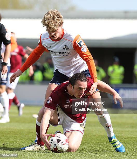 John-Joe O'Toole of Northampton Town under pressure from Cameron McGeehan of Luton Town during the Sky Bet League Two match between Northampton Town...