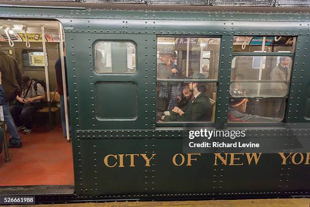 New Yorkers, tourists and subway buffs travel on a vintage MTA Nostalgia Train Christmas season ride on Sunday, December 27, 2015. The straps,...