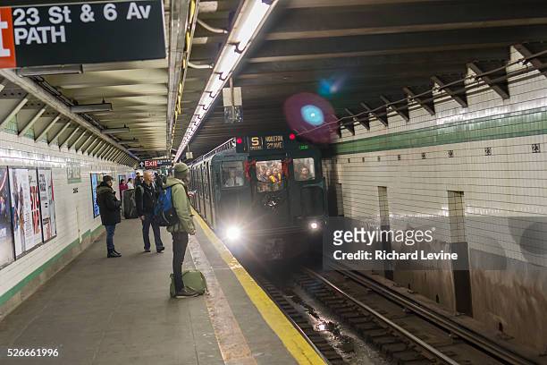 Vintage MTA Nostalgia Train Christmas season train arrives at the W23rd Street station on Sunday, December 27, 2015. The straps, ceiling fans and...