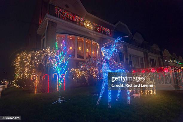 Crowds of tourists and even New Yorkers descend on the Dyker Heights neighborhood of Brooklyn in New York to view the extravagant display of...