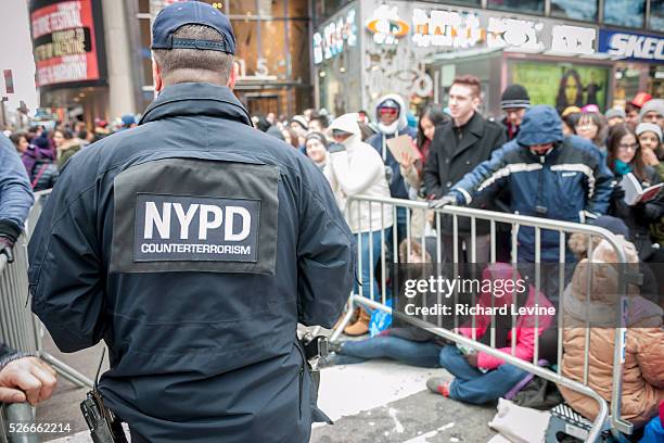 An NYPD Counterterrorism officer stands guard outside the pens in Times Square in New York hours before the New Year'e Eve ball drop on Thursday...
