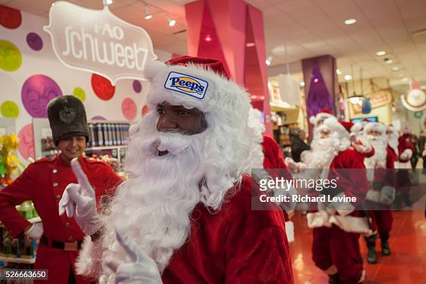 Twenty Santa Claus' bunny hop for Peeps through the FAO Schweetz candy department in the iconic FAO Schwarz toy store in Midtown Manhattan in New...