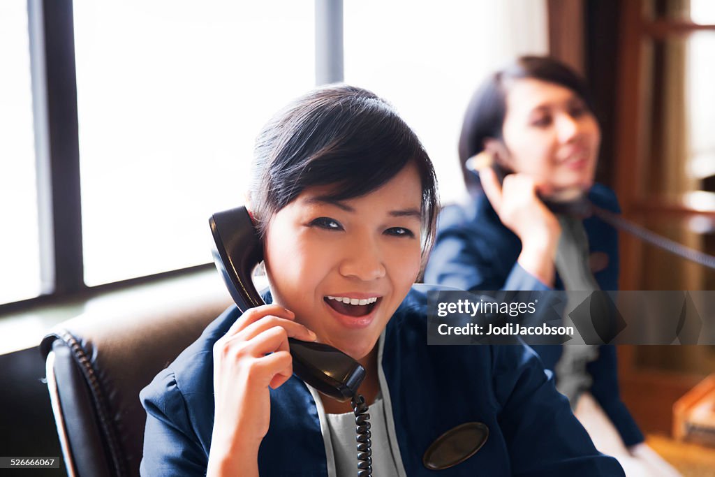 A female hotel concierges are talking to hotel guests