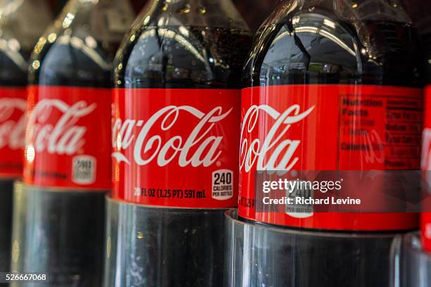 Bottles of Coca-Cola in a grocery store in New York on Tuesday, April 1, 2014. The Coca-Cola Co. Is scheduled to report its fourth-quarter financials...