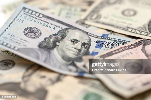 One hundred dollar bill with Benjamin Franklin is seen amongst other bills in New York on Friday, February 19, 2016. The U.S. Treasury Dept. Is...