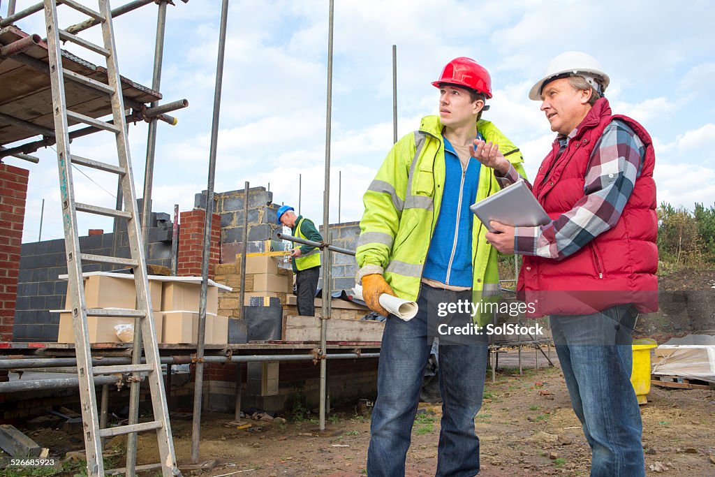 Builders Looking at Digital Tablet