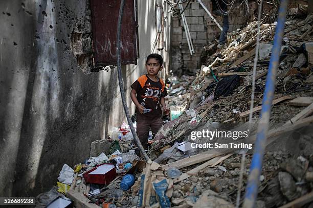 Palestinian boy who recently fled fighting in Yarmouk Camp in Syria, plays outside his family's new home in Bourj al Barajneh Palestinian refugee...