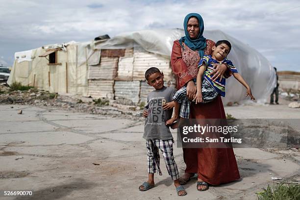 Abir Battal a mother of 3, holds her 12-year-old nephew disabled orphaned nephew Iz Eldin in an informal refugee settlement in Anfie, north Lebanon,...