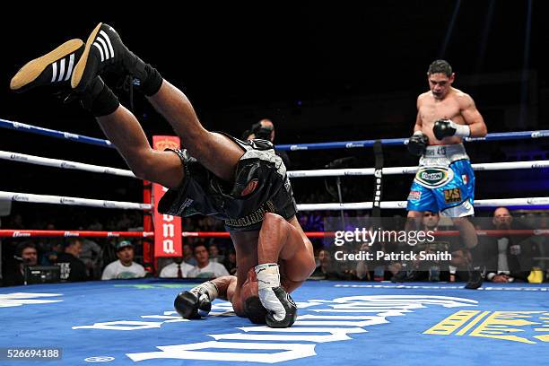 James DeGale of England rolls backwards after losing his footing against Rogelio Medina of Mexico in their IBF super middleweights championship bout...