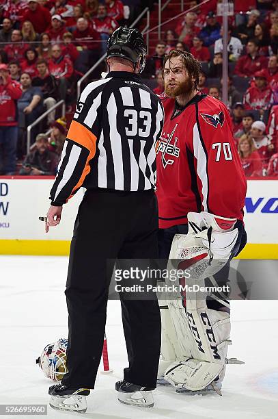 Braden Holtby of the Washington Capitals talks with referee Kevin Pollock after a play in the second period in Game Two of the Eastern Conference...