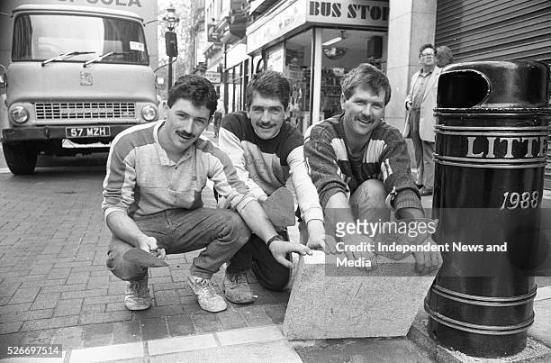 The last granite slab being laid in Grafton St. It was put into place by Nicky Whelan, left, and brothers Vincent, centre, and Damien McConnell of...