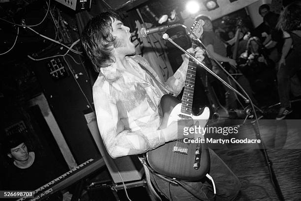 Gaz Coombes of Supergrass performs on stage with his brother Rob Coombes on keyboards behind, Moles Club, Bath, United Kingdom, 1995.