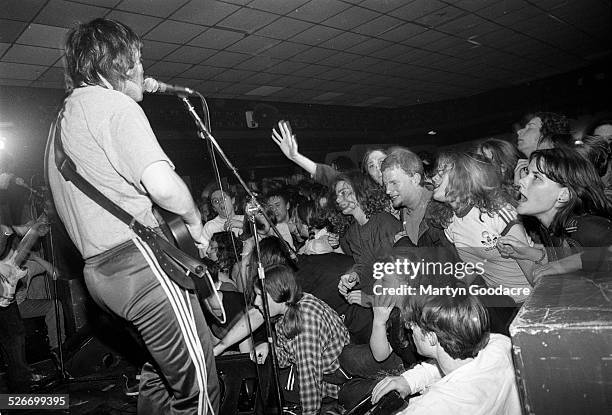 Gaz Coombes of Supergrass performs on stage, showing Britpop fans reaching out from the front rows of the audience, at Moles Club, Bath, United...