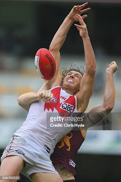 Kurt Tippett of the Swans takes a mark over Daniel Merrett of the Lions during the round six AFL match between the Brisbane Lions and the Sydney...