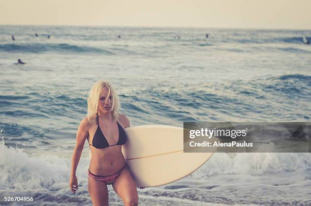 blonde caucasian surfer girl - sunset on atlantic surf beach - san sebastian spain beach stock pictures, royalty-free photos & images
