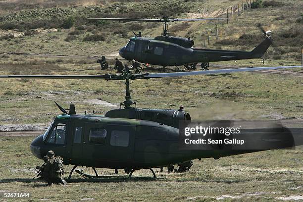 German army infantry soldiers and Bell UH-1D helicopters participate in the European Challenge 2005 joint military exercises, April 20, 2005 in...