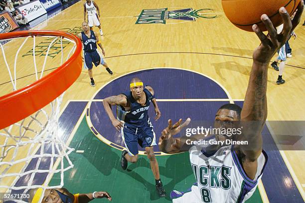 Joe Smith of the Milwaukee Bucks shoots a layup over Stromile Swift of the Memphis Grizzlies during the game on April 1, 2005 at the Bradley Center...