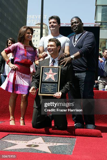 Television host Ryan Seacrest poses with American Idol judges Paula Abdul, Simon Cowell and Randy Jackson, after receiving a star on the Hollywood...