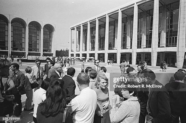 Film critic Annette Michelson, left, speaks with independent filmmaker Shirley Clarke, in checked coat, as a group of members and attendees of the...