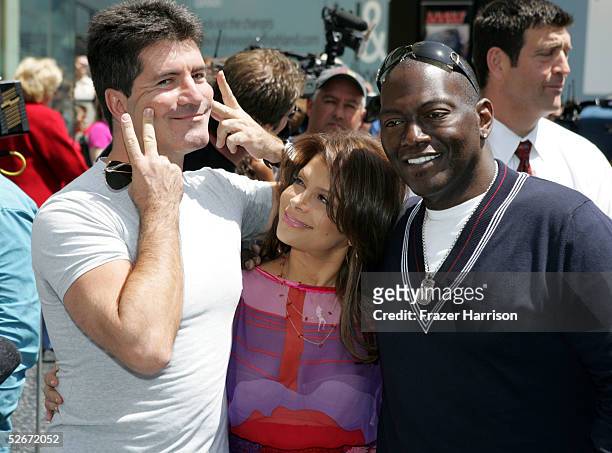 American Idol judges Simon Cowell, Paula Abdul and Randy Jackson attend a ceremony presenting television host Ryan Seacrest with a star on the...