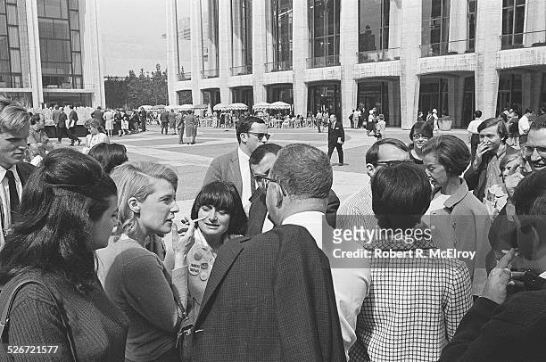 Film critic Annette Michelson, with cigarette, speaks with a group of members and attendees of the New York Film Festival, including filmmaker Agnes...
