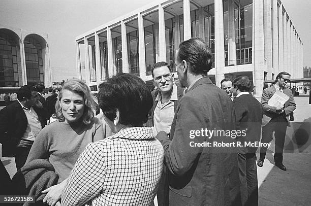 Film critic Annette Michelson, left, speaks with independent filmmaker Shirley Clarke, in checked coat, as a group of members and attendees of the...