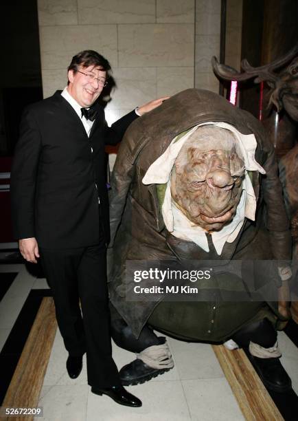 Stephen Fry poses with a Vogon costume from the film "The Hitchhiker's Guide to the Galaxy" during the aftershow party following the world premiere...