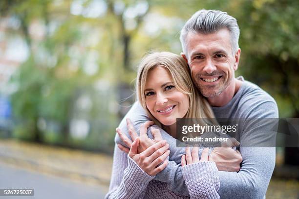 loving couple outdoors - mid adult stock pictures, royalty-free photos & images