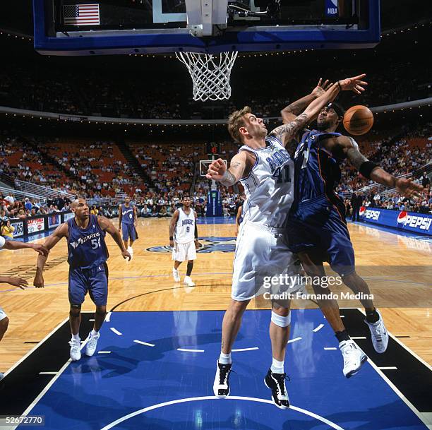 Larry Hughes of the Washington Wizards gets fouled by Mario Kasun of the Orlando Magic during a game at TD Waterhouse Centre on April 1, 2005 in...