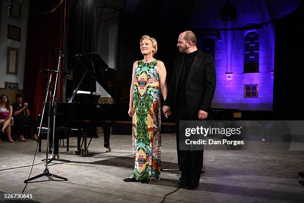 Soprano singer Angela Denoke and pianist Kirill Gerstein bow to the audience in curtain call at the end of performance in concert at the Seventeenth...